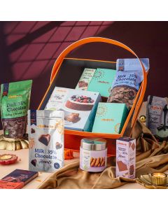 Orange leather basket with assorted luxury chocolates and baking mixes
